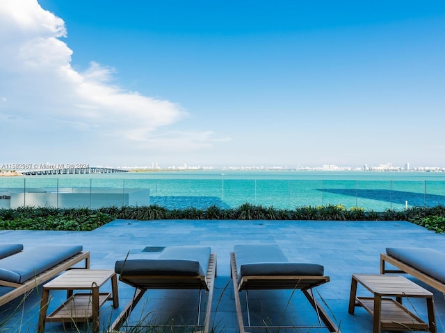 view of swimming pool featuring a water view