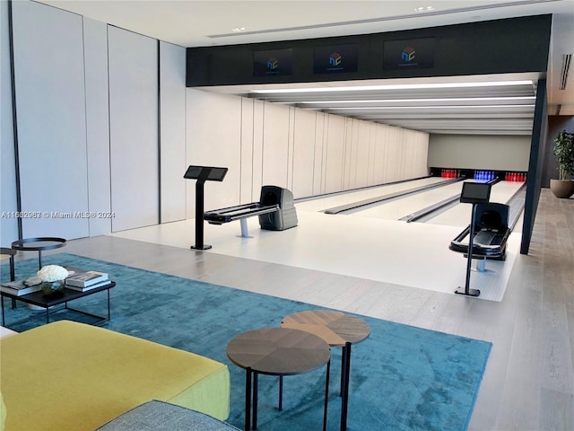 interior space featuring light wood-type flooring and a bowling alley