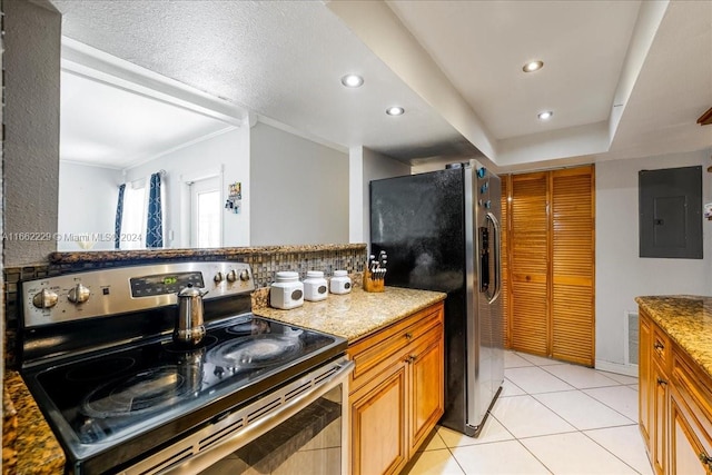 kitchen featuring appliances with stainless steel finishes, decorative backsplash, light stone countertops, light tile patterned floors, and electric panel