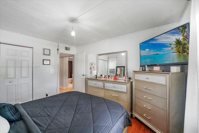 bedroom featuring hardwood / wood-style flooring and a closet