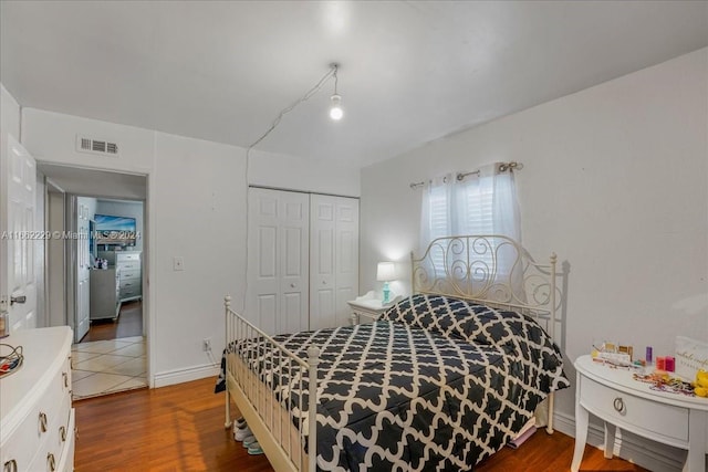 bedroom with a closet and hardwood / wood-style floors