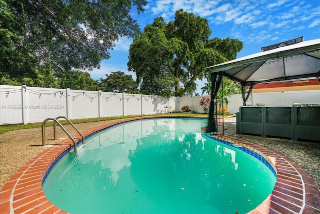 view of swimming pool featuring a gazebo