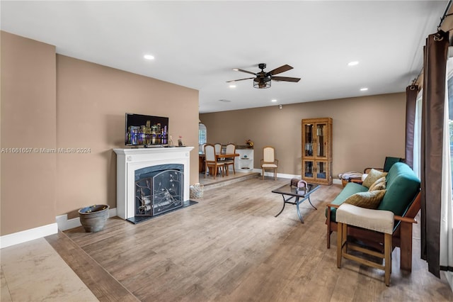 living room featuring ceiling fan and hardwood / wood-style floors