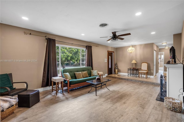 living room with light wood-type flooring and ceiling fan