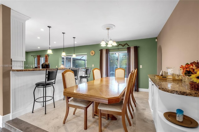 dining area featuring an inviting chandelier