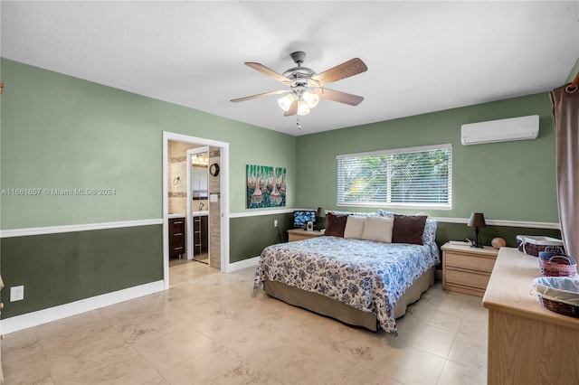 bedroom with ceiling fan, connected bathroom, and an AC wall unit