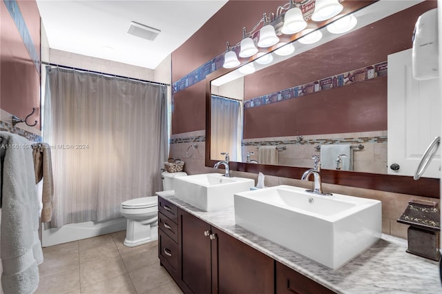 bathroom with tile walls, tile patterned flooring, vanity, and toilet