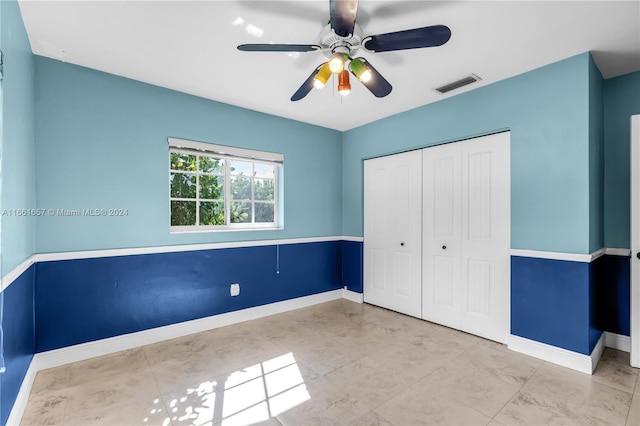 unfurnished bedroom featuring a closet and ceiling fan