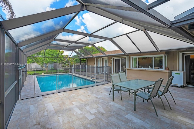 view of swimming pool with a patio and a lanai