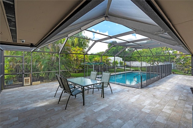 view of swimming pool with glass enclosure and a patio area