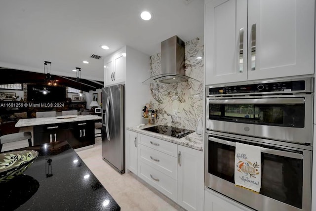 7706 SW 74th Ln, Miami, FL 33143 - kitchen featuring visible vents, wall chimney exhaust hood, appliances with stainless steel finishes, white cabinetry, and light stone counters