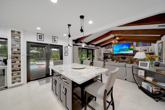 7706 SW 74th Ln, Miami, FL 33143 - kitchen with a kitchen breakfast bar, french doors, a center island, ceiling fan, and vaulted ceiling with beams