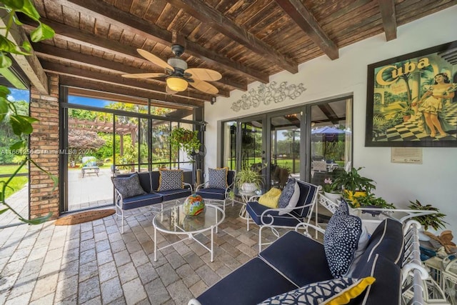 sunroom / solarium featuring ceiling fan, wood ceiling, and beam ceiling