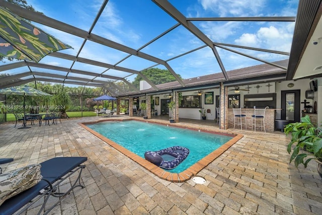 7706 SW 74th Ln, Miami, FL 33143 - pool with a ceiling fan, outdoor dry bar, a patio area, a lanai, and outdoor dining space