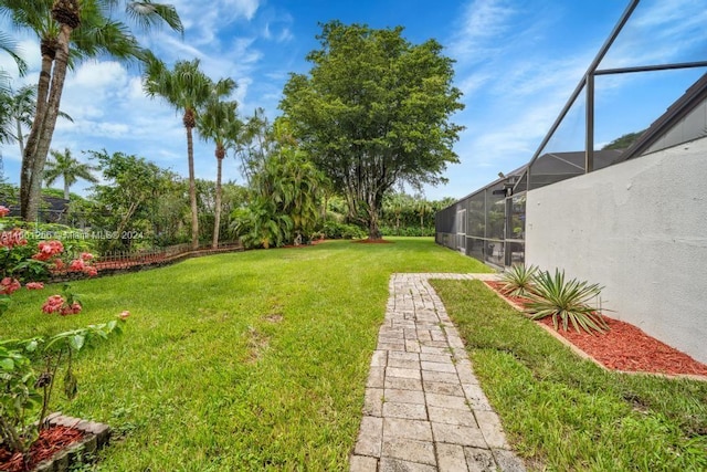 view of yard with glass enclosure