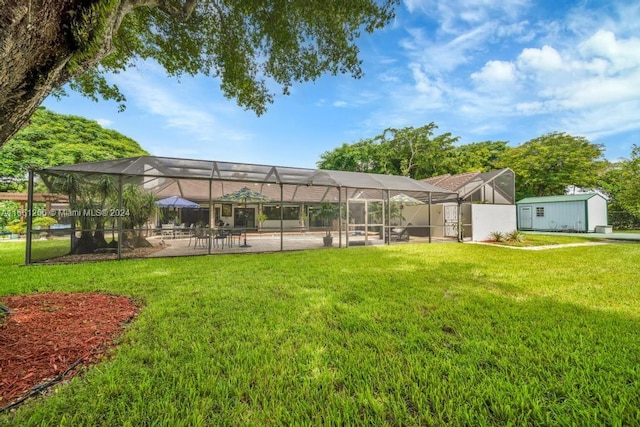 view of yard with a swimming pool, a lanai, and a patio area