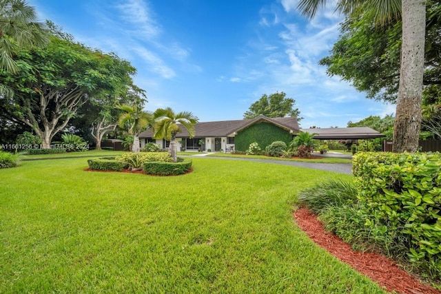 ranch-style home featuring a front yard