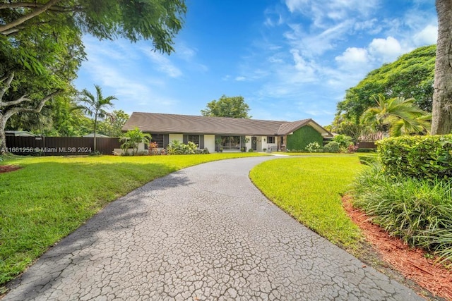 ranch-style home with a front yard