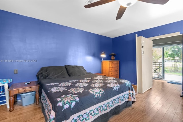 bedroom with wood-type flooring, ceiling fan, and access to exterior