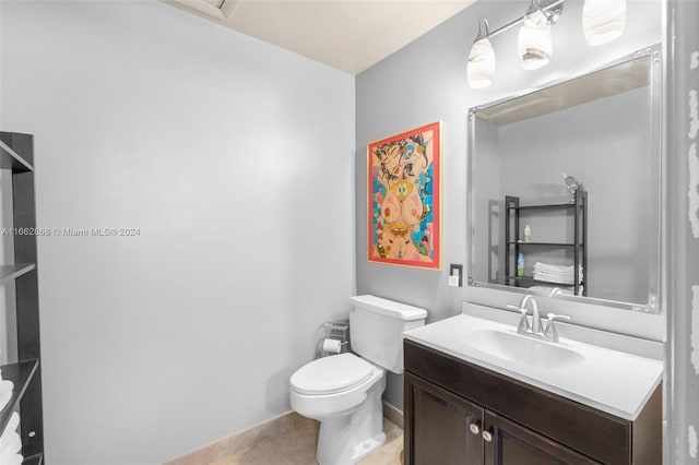 bathroom featuring vanity, tile patterned flooring, and toilet