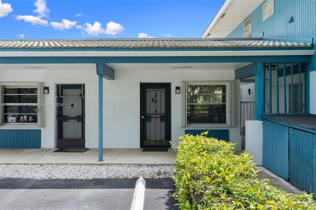 property entrance with covered porch