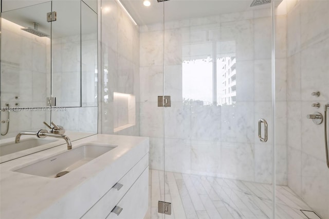 bathroom featuring walk in shower and vanity