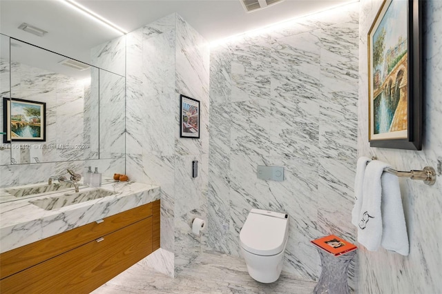 bathroom with tile walls, vanity, toilet, and an enclosed shower