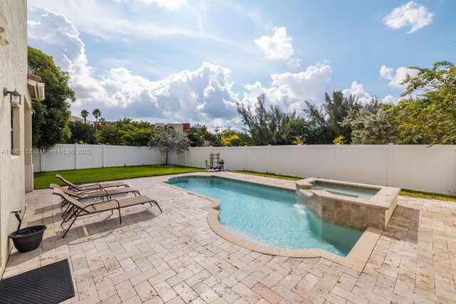 view of pool with an in ground hot tub and a patio area