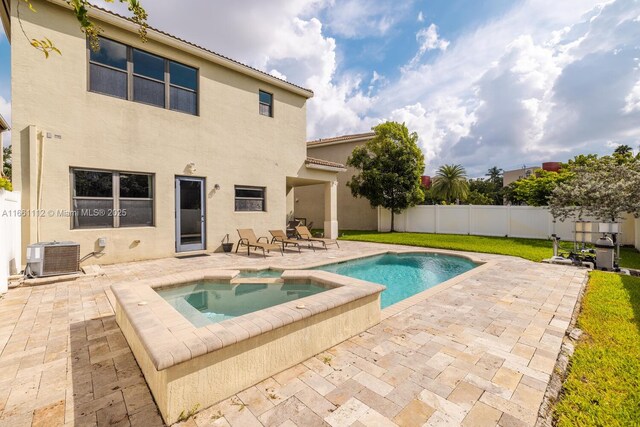 view of pool featuring an in ground hot tub, a patio area, and central air condition unit