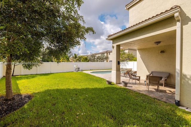 view of yard with a fenced in pool and a patio