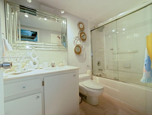 full bathroom featuring enclosed tub / shower combo, vanity, and toilet