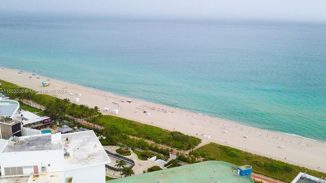 bird's eye view with a water view and a beach view