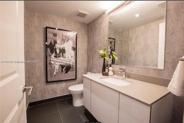 bathroom featuring toilet, tile patterned flooring, visible vents, and vanity