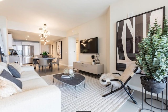 living room featuring baseboards and a chandelier