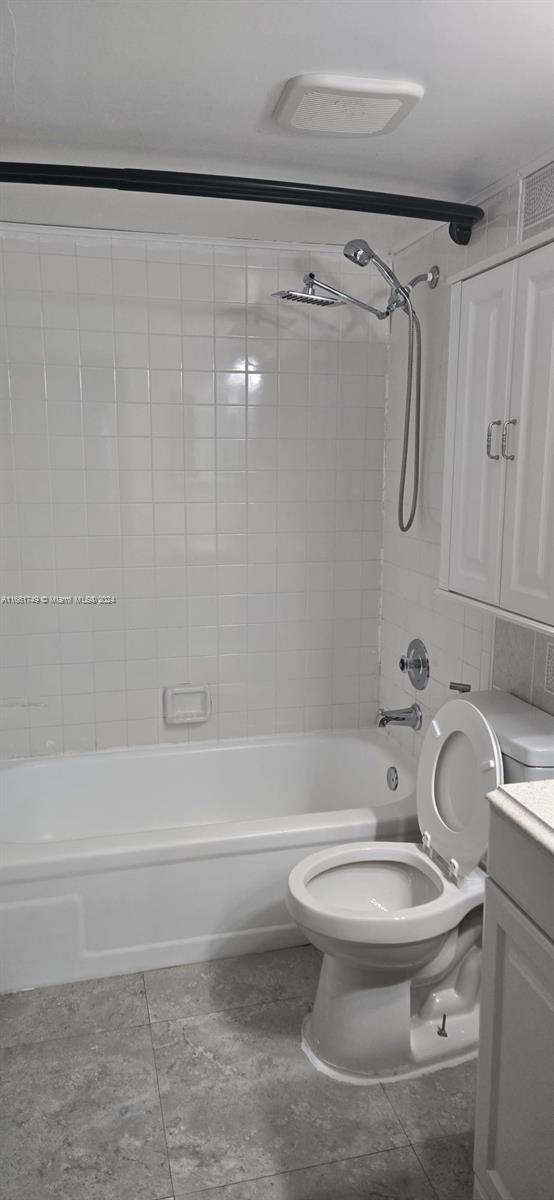 full bathroom featuring vanity, toilet, and tiled shower / bath