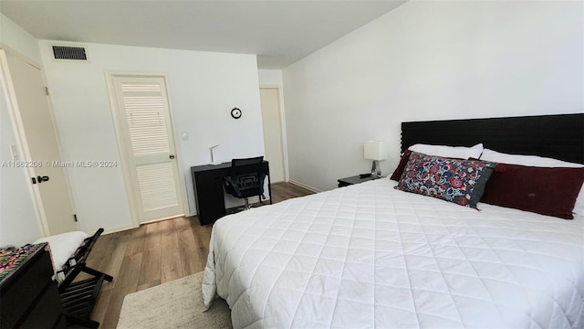 bedroom with wood-type flooring