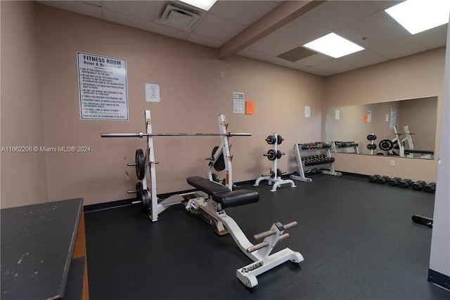 gym with a paneled ceiling