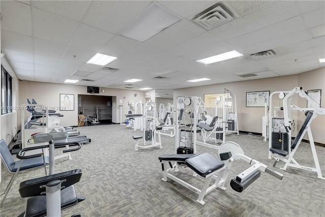 exercise room with carpet and a paneled ceiling