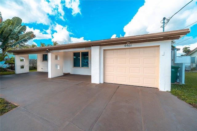 ranch-style house with fence and stucco siding