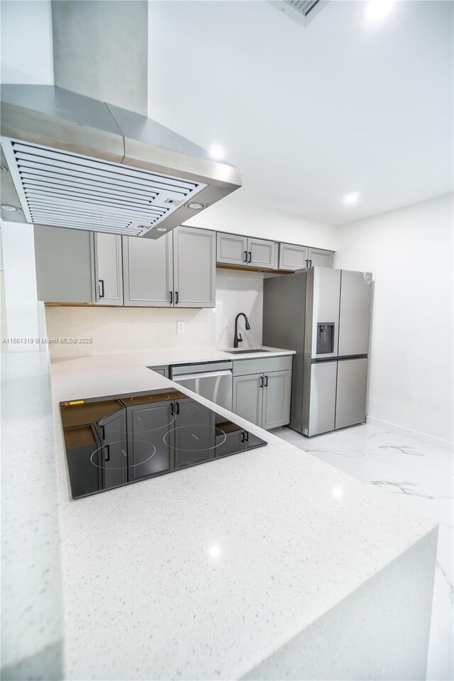 kitchen featuring island range hood, stainless steel appliances, gray cabinetry, and sink