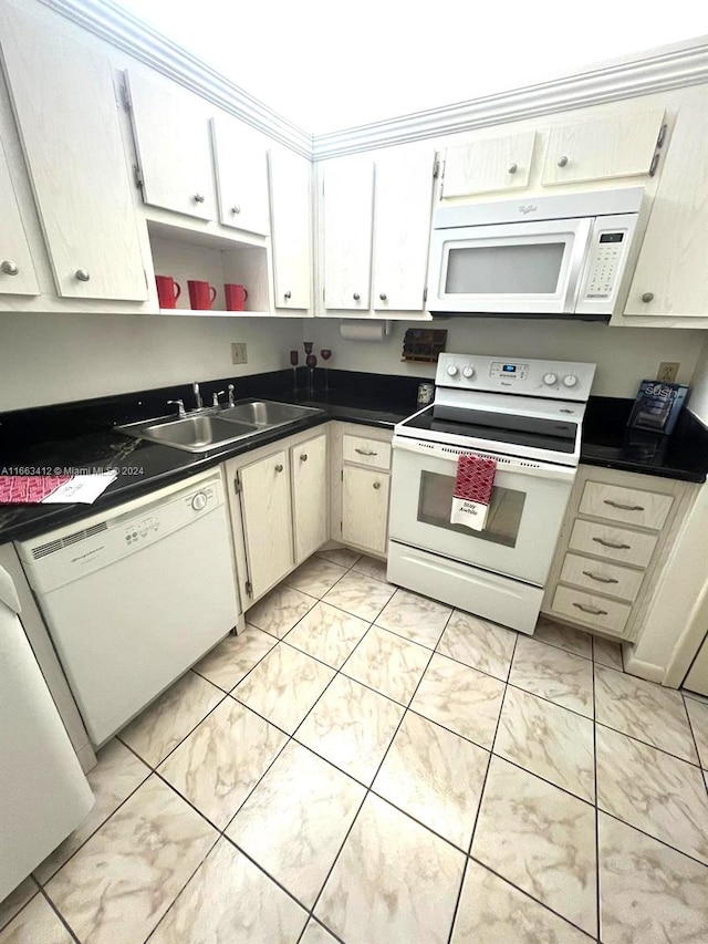 kitchen with sink, white cabinets, and white appliances