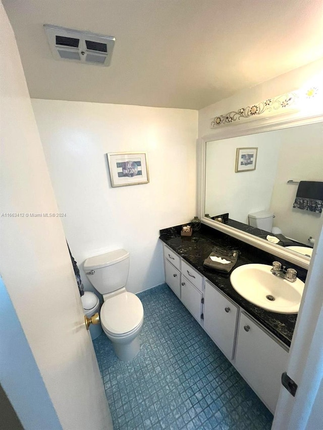 bathroom featuring toilet and vanity