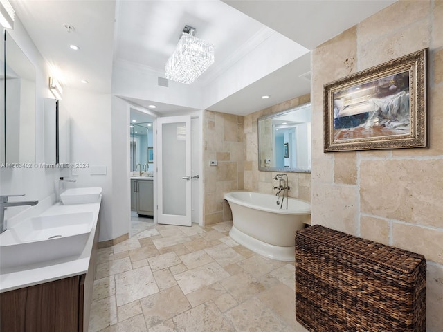 bathroom with vanity, tile walls, ornamental molding, and a bath