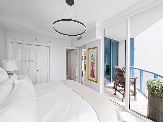 bedroom featuring expansive windows, a closet, crown molding, and access to exterior