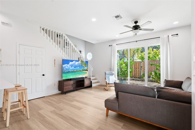 living room with ceiling fan and light hardwood / wood-style floors