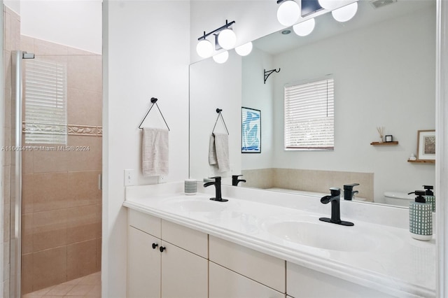 bathroom with vanity, a tile shower, and toilet