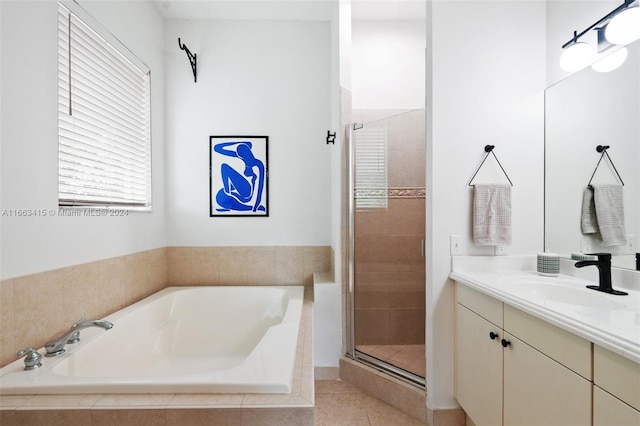 bathroom featuring tile patterned flooring, vanity, and plus walk in shower