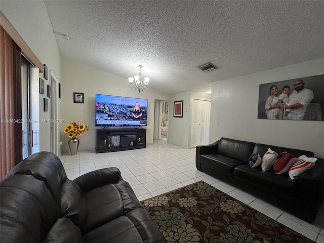 living room featuring visible vents, a textured ceiling, an inviting chandelier, light tile patterned floors, and vaulted ceiling