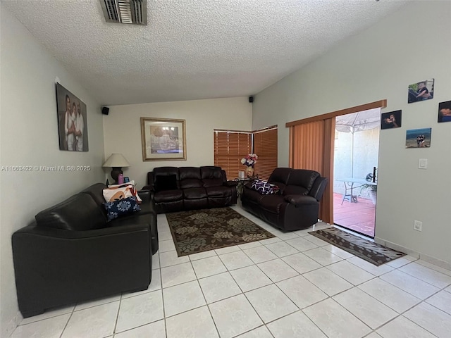 15235 SW 64th Ter Unit 9-35, Miami, FL 33193 - living area featuring vaulted ceiling, light tile patterned floors, visible vents, and a textured ceiling