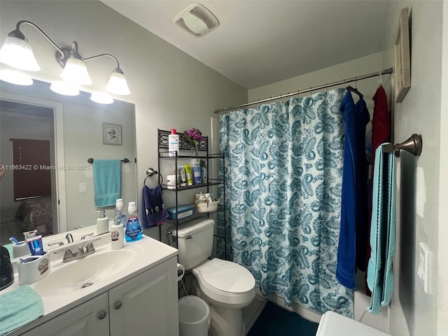 bathroom featuring vanity, toilet, a shower with curtain, and visible vents